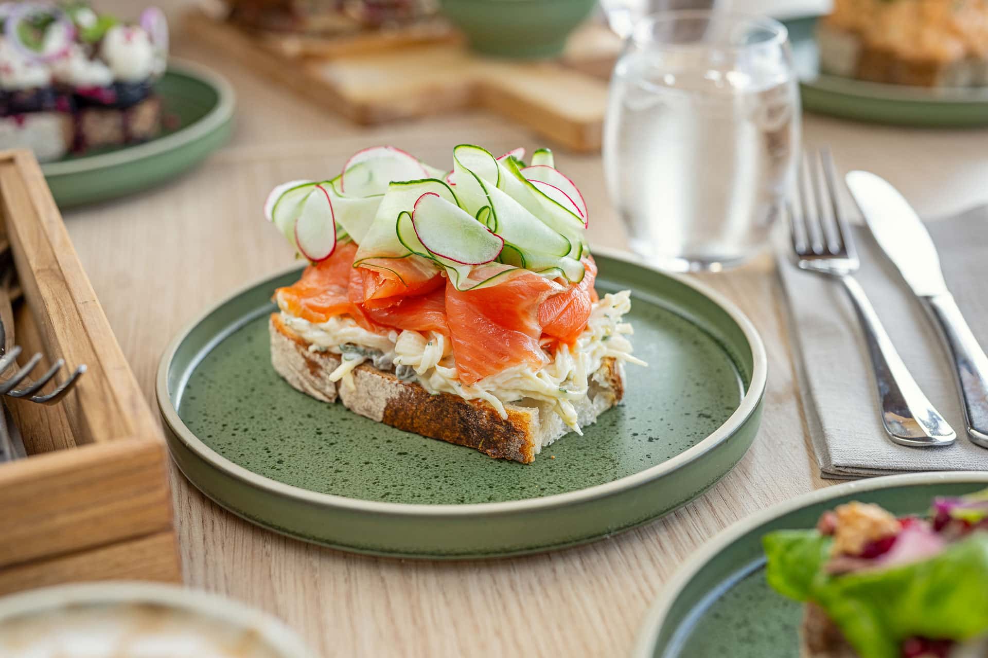 Open sandwich with salmon and fresh herbs at Restaurant SKREI