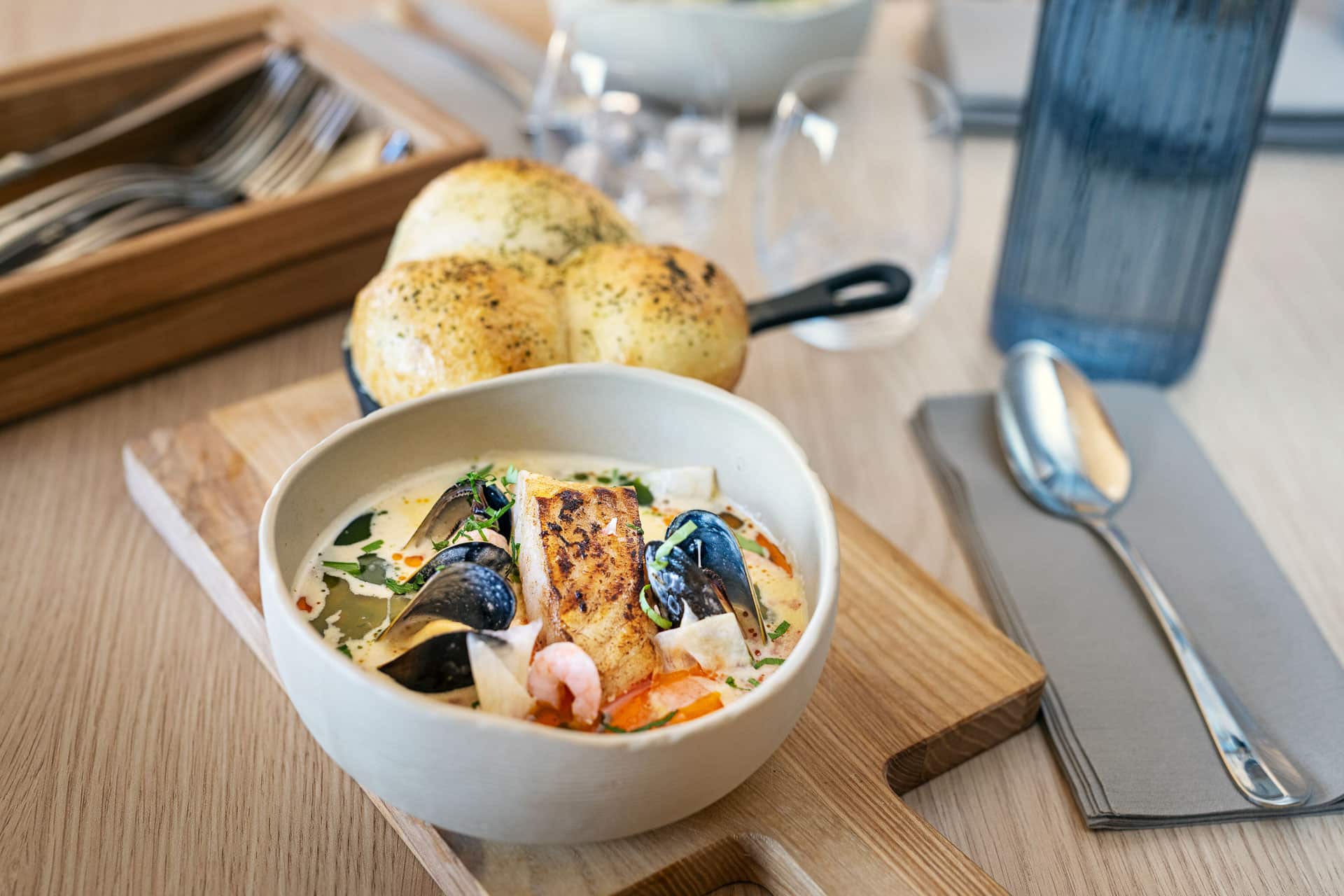 Lunch dish with bread served at Restaurant SKREI in Lofoten