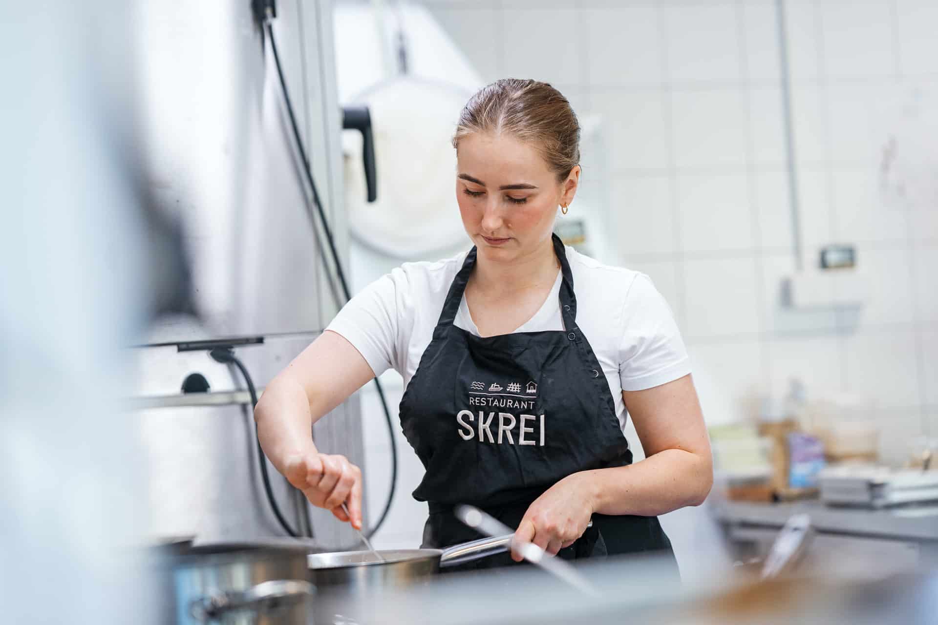 Chef working in the kitchen at Restaurant SKREI in Lofoten
